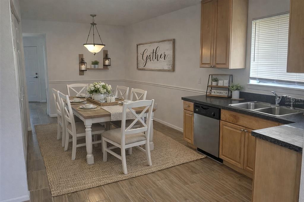 1550 South Belcher Road, Unit 412 Clearwater, FL 33764 - Photo 5 of 40 a kitchen with granite countertop stainless steel appliances a sink table and chairs in it