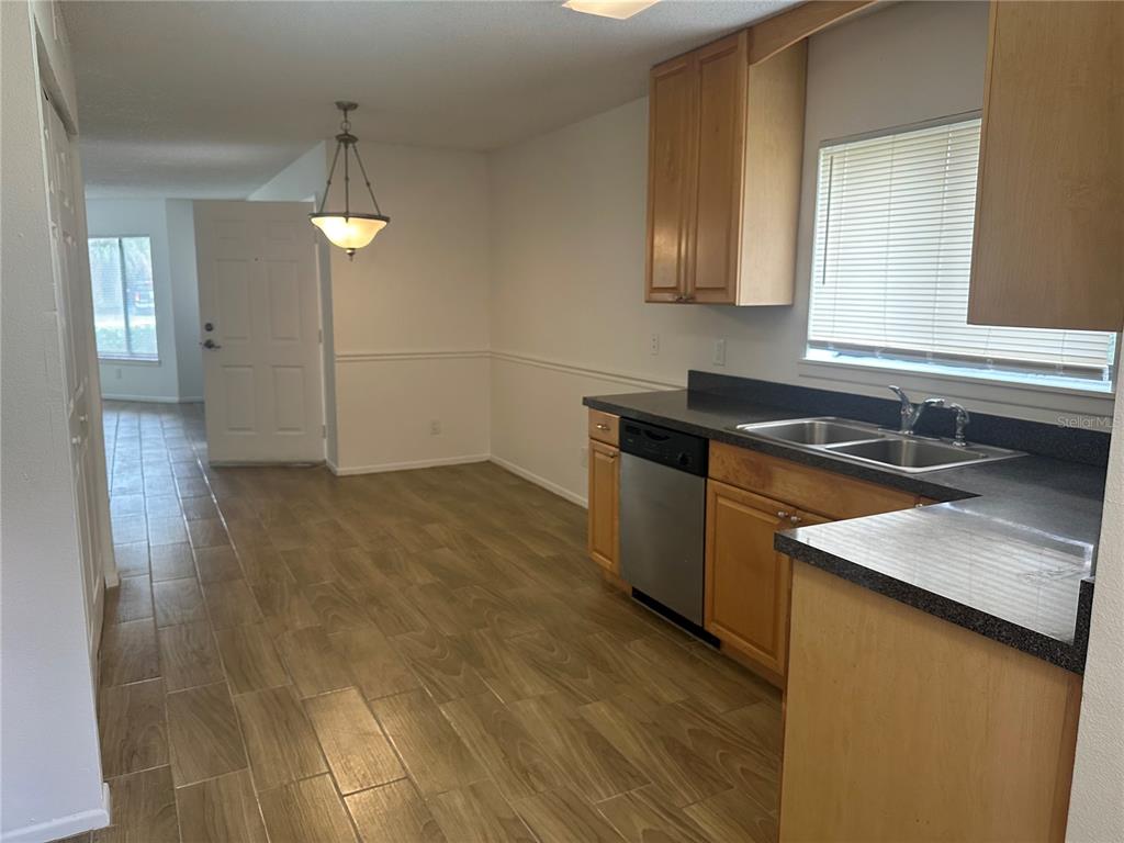 1550 South Belcher Road, Unit 412 Clearwater, FL 33764 - Photo 6 of 40 a kitchen that has a sink cabinets and a wooden floor