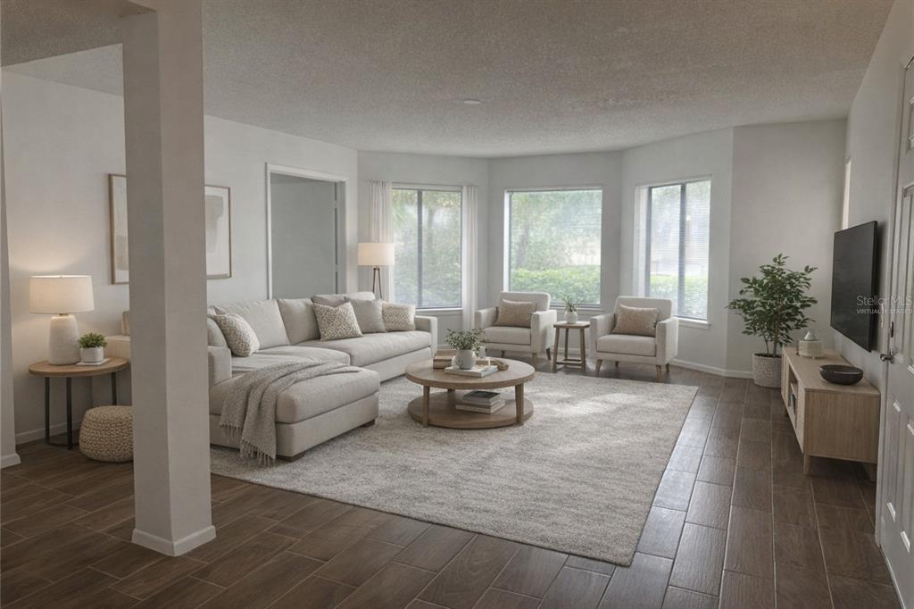 1550 South Belcher Road, Unit 412 Clearwater, FL 33764 - Photo 9 of 40 a living room with furniture and a flat screen tv