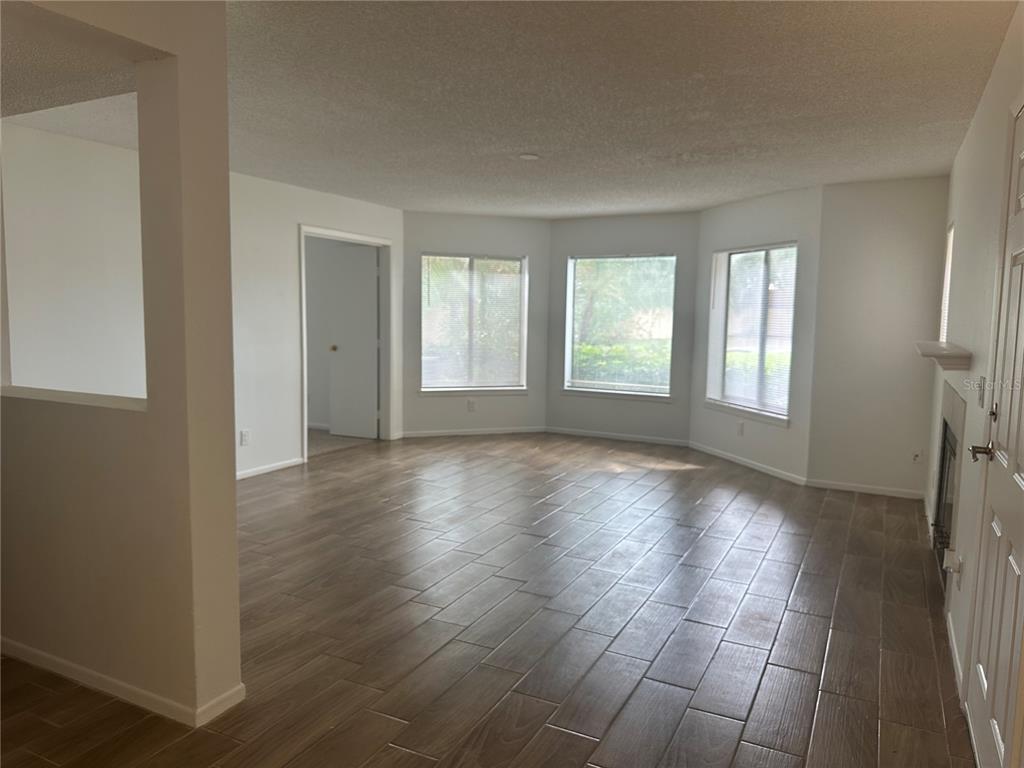 1550 South Belcher Road, Unit 412 Clearwater, FL 33764 - Photo 10 of 40 an empty room with wooden floor and windows