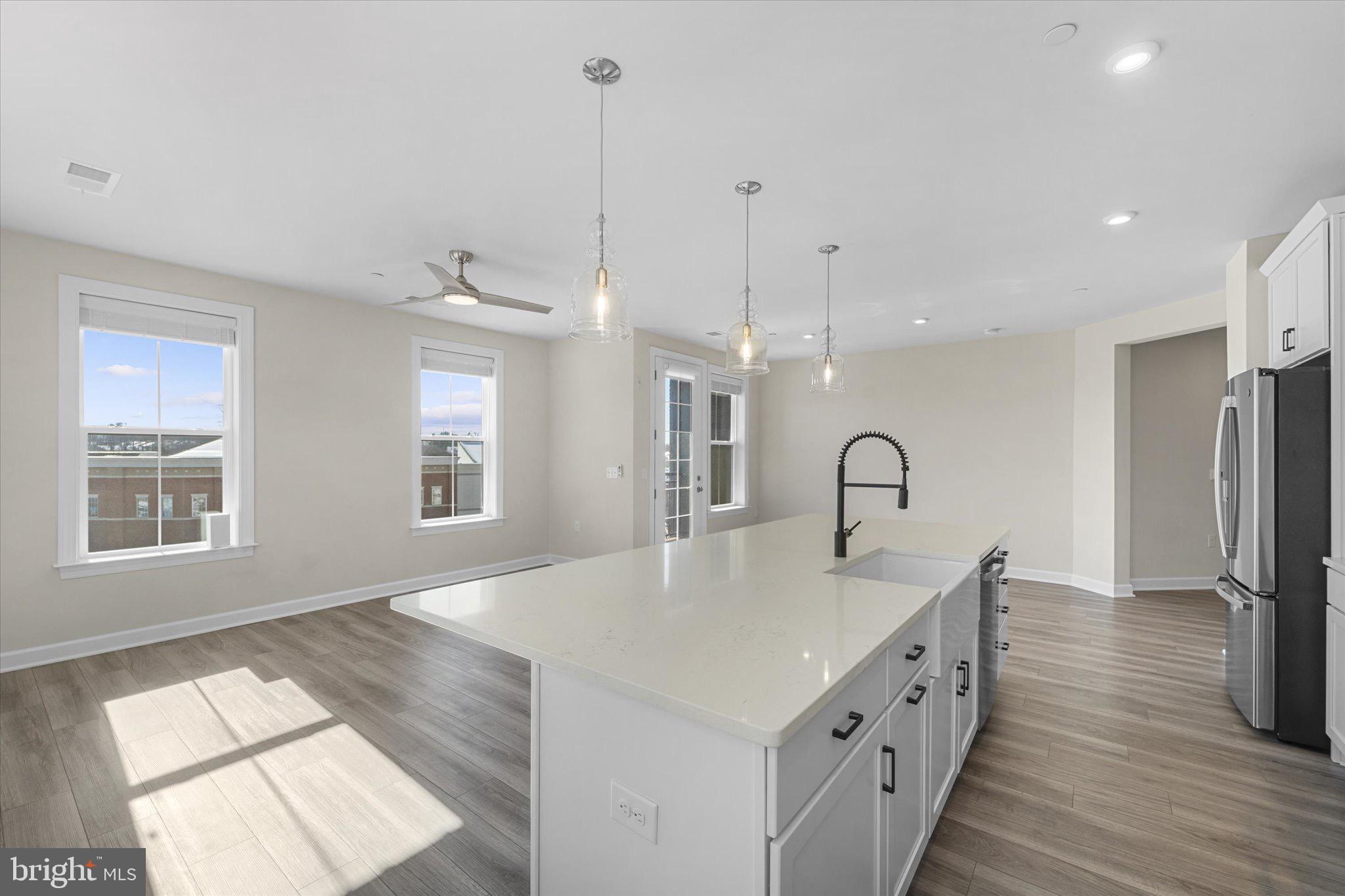 3927 Fair Ridge Drive, Unit 409 Fairfax, VA 22033 - Photo 36 of 37 a kitchen with windows and refrigerator