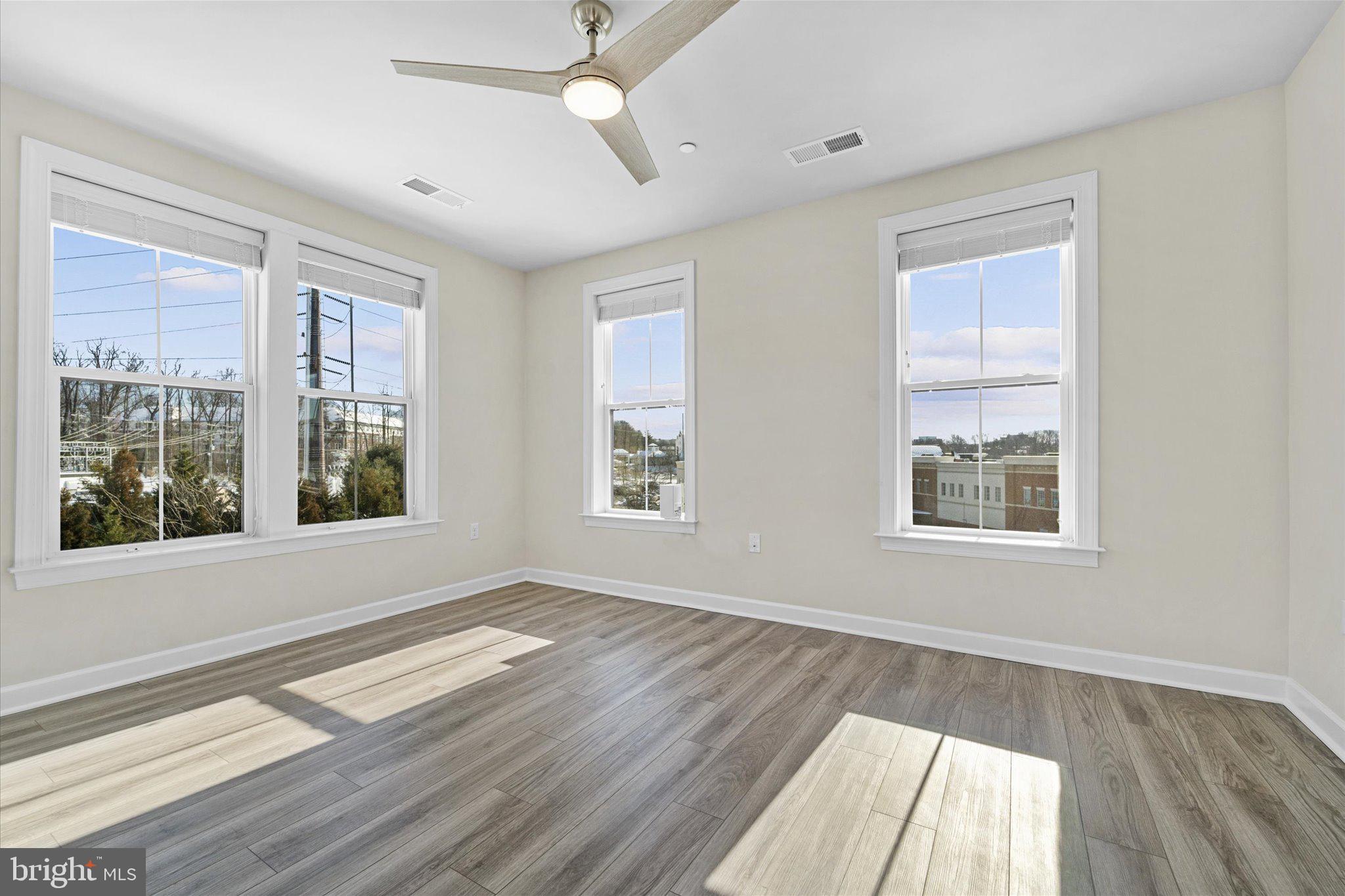 3927 Fair Ridge Drive, Unit 409 Fairfax, VA 22033 - Photo 12 of 37 a view of an empty room with wooden floor and a window