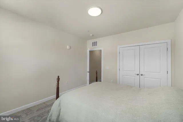 a bathroom with a sink a light fixture and a glass door shower