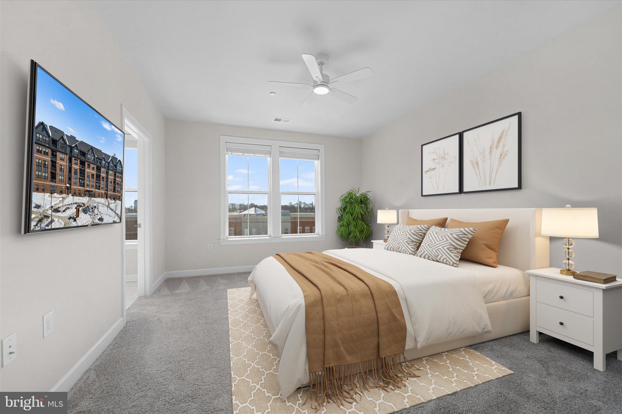 3927 Fair Ridge Drive, Unit 409 Fairfax, VA 22033 - Photo 4 of 37 a bedroom with a large bed and a window