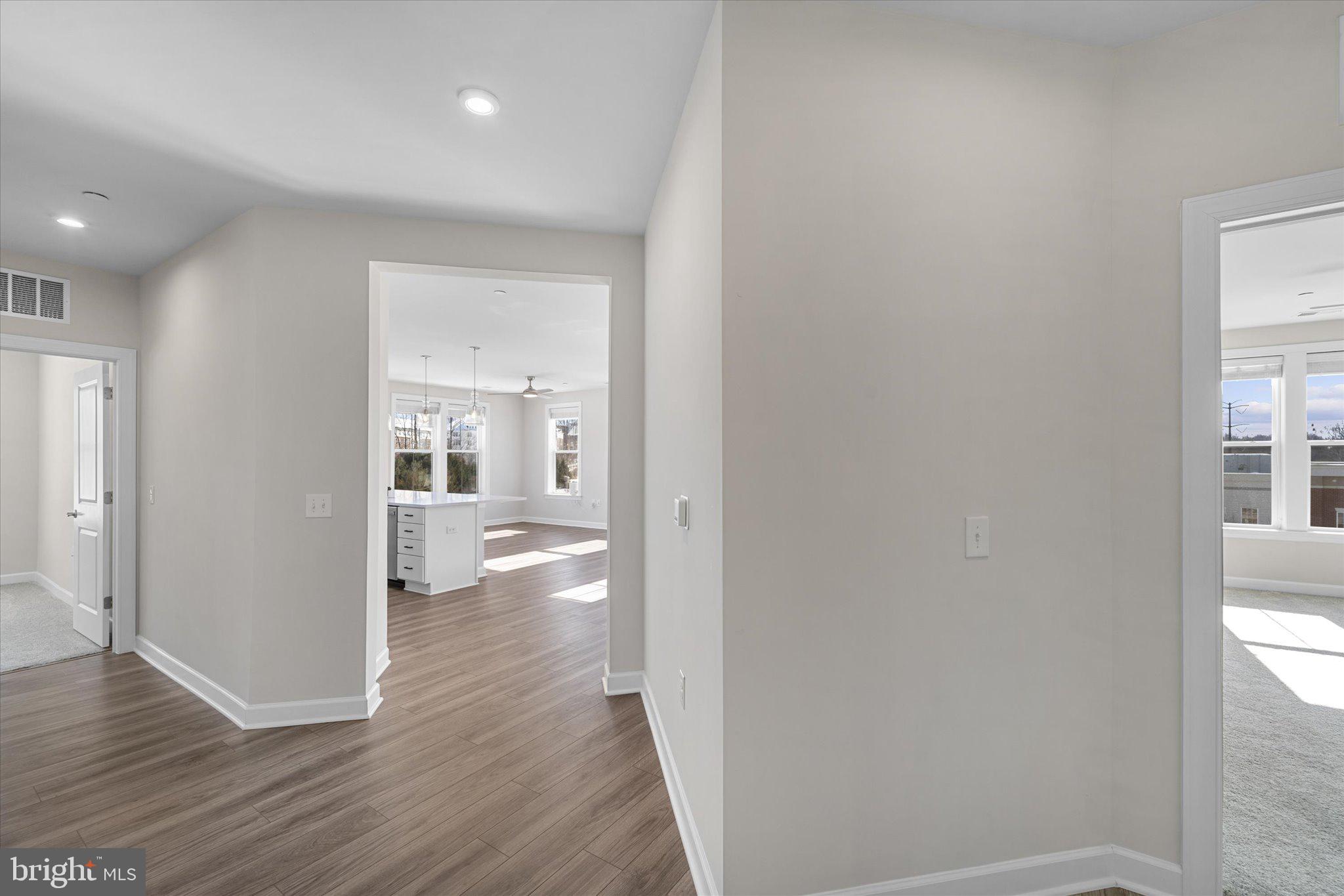 3927 Fair Ridge Drive, Unit 409 Fairfax, VA 22033 - Photo 8 of 37 a view of a hallway with wooden floor and a bathroom