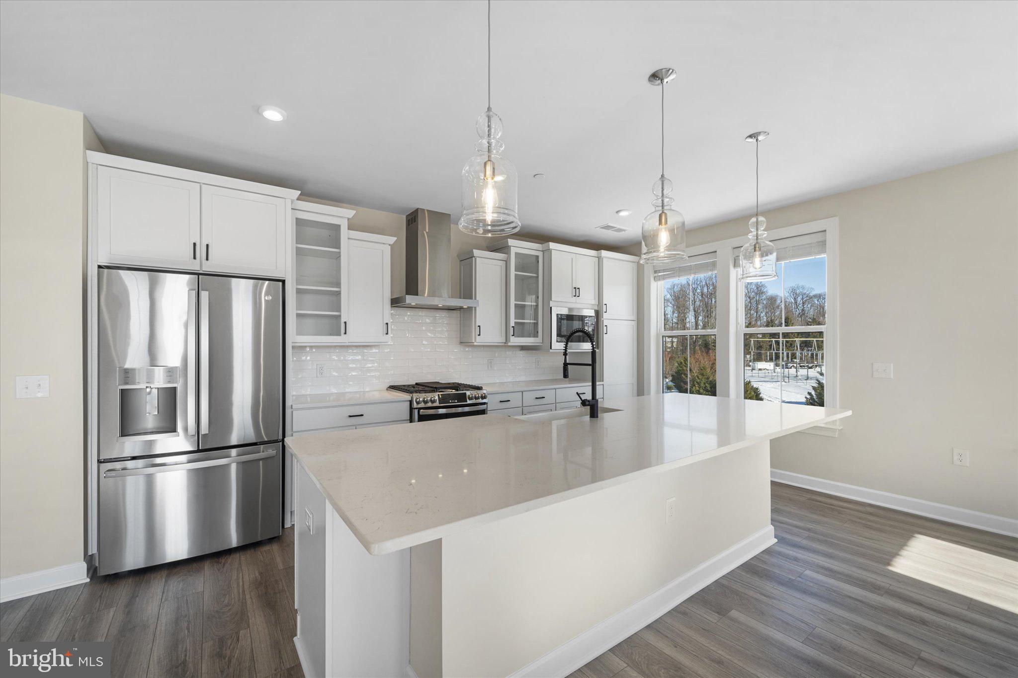 3927 Fair Ridge Drive, Unit 409 Fairfax, VA 22033 - Photo 9 of 37 a kitchen with stainless steel appliances granite countertop a refrigerator a sink and a stove