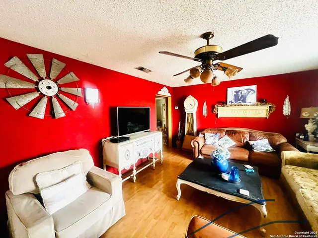 a living room with furniture gym equipment and a flat screen tv