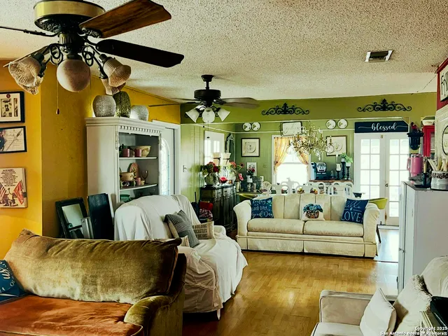 a living room with furniture and a chandelier
