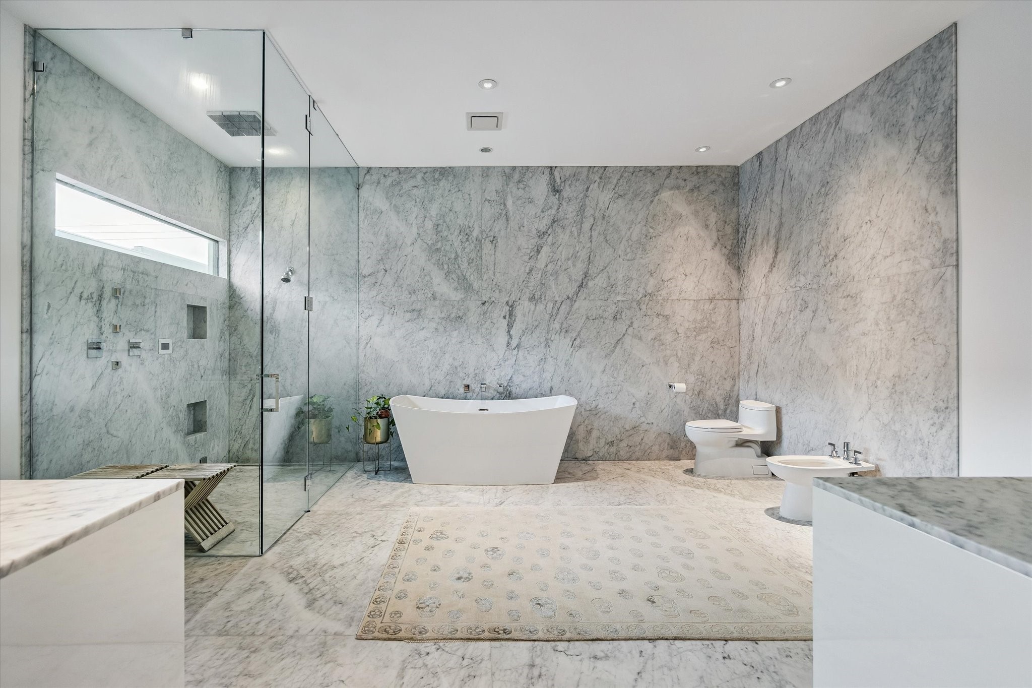 1527 Indiana Street Houston, TX 77006 - Photo 19 of 30 Primary bath - featuring a commercial grade steam shower with an infinity drain and a wall of framelessglass and the freestanding tub takes center stage.