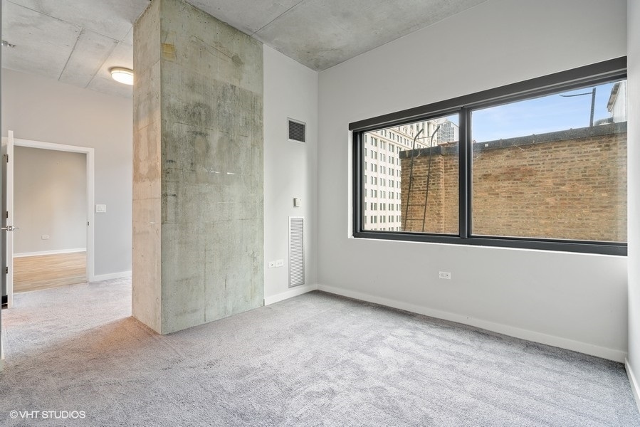 235 West Van Buren Street, Unit 1502 Chicago, IL 60607 - Photo 15 of 30 an empty room with windows