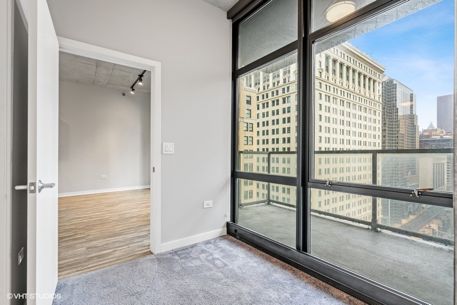 235 West Van Buren Street, Unit 1502 Chicago, IL 60607 - Photo 18 of 30 a view of an empty room and window