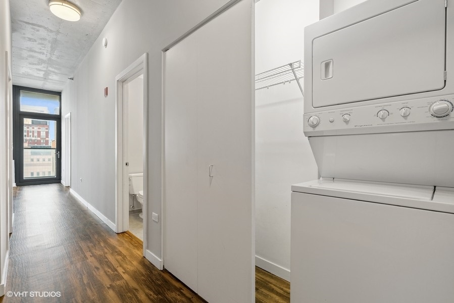 235 West Van Buren Street, Unit 1502 Chicago, IL 60607 - Photo 8 of 30 a view of washer and dryer with wooden floor