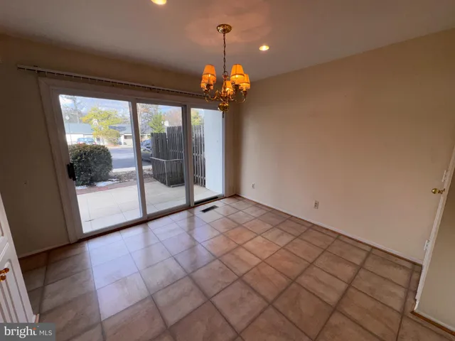 a kitchen with granite countertop a sink a stove and cabinets