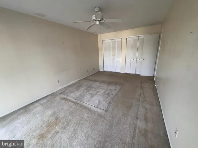 a bathroom with a granite countertop sink and a tub