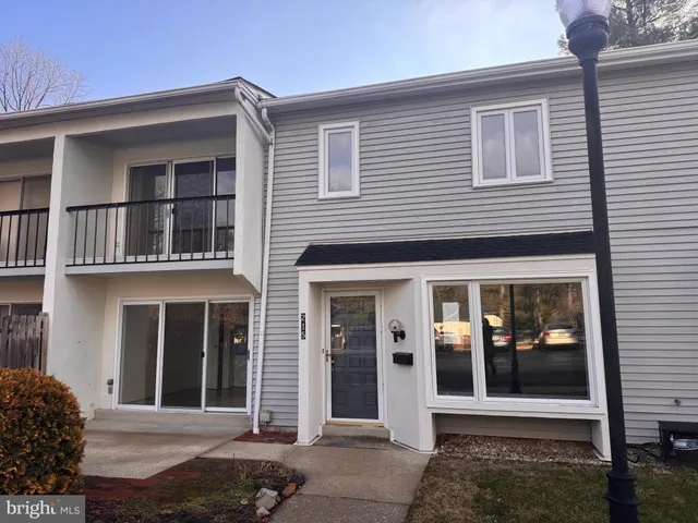 a view of a brick house with large windows