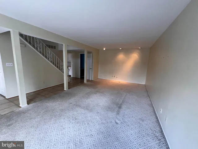 a view of a big room with entryway and stairs