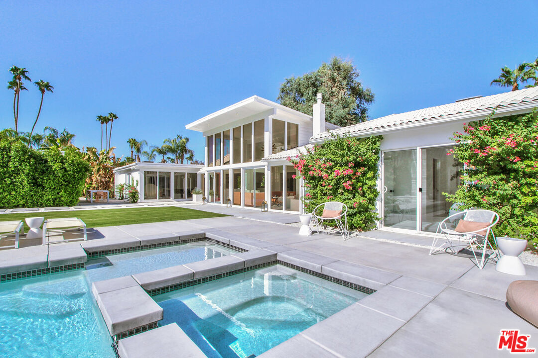 a house view with a seating space and garden
