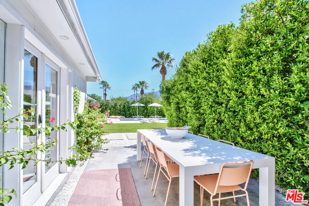 678 South Thornhill Road Palm Springs, CA 92264 - Photo 20 of 21 a view of a patio with table and chairs and potted plants