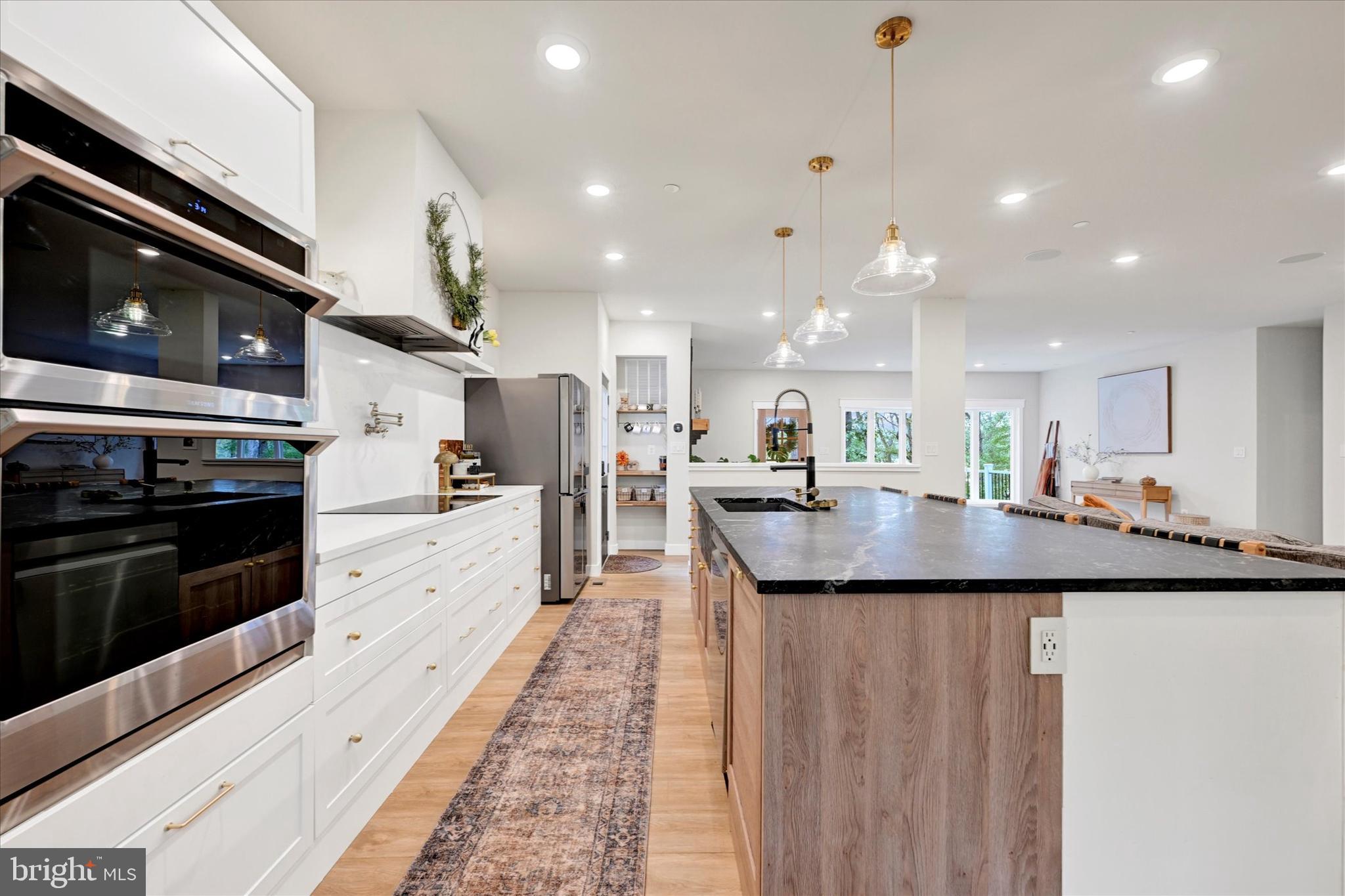 5437 Glen Arm Road Glen Arm, MD 21057 - Photo 21 of 45 a large kitchen with granite countertop a stove top oven a sink a counter space and cabinets