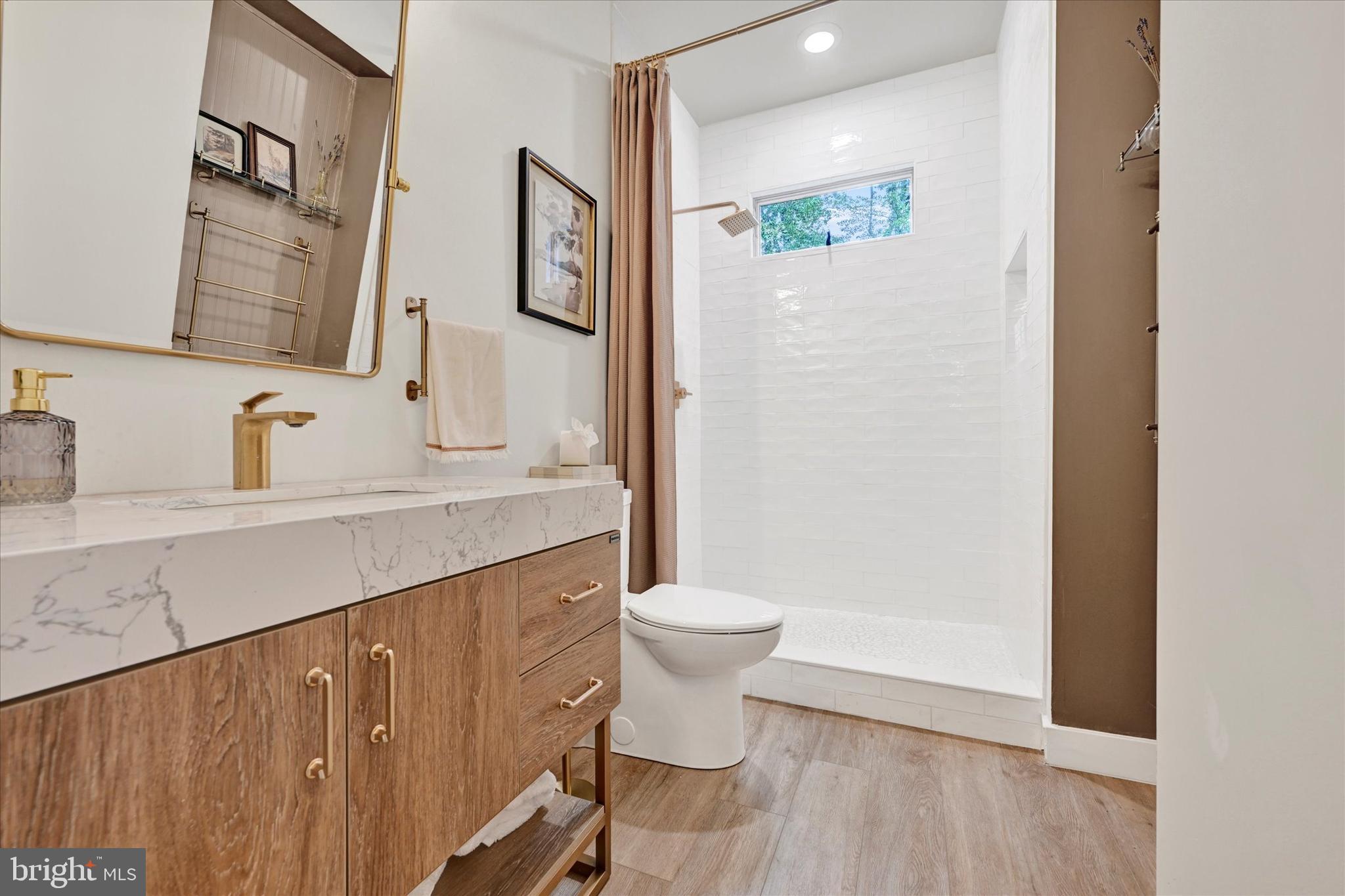 5437 Glen Arm Road Glen Arm, MD 21057 - Photo 22 of 45 a bathroom with a sink a toilet and shower