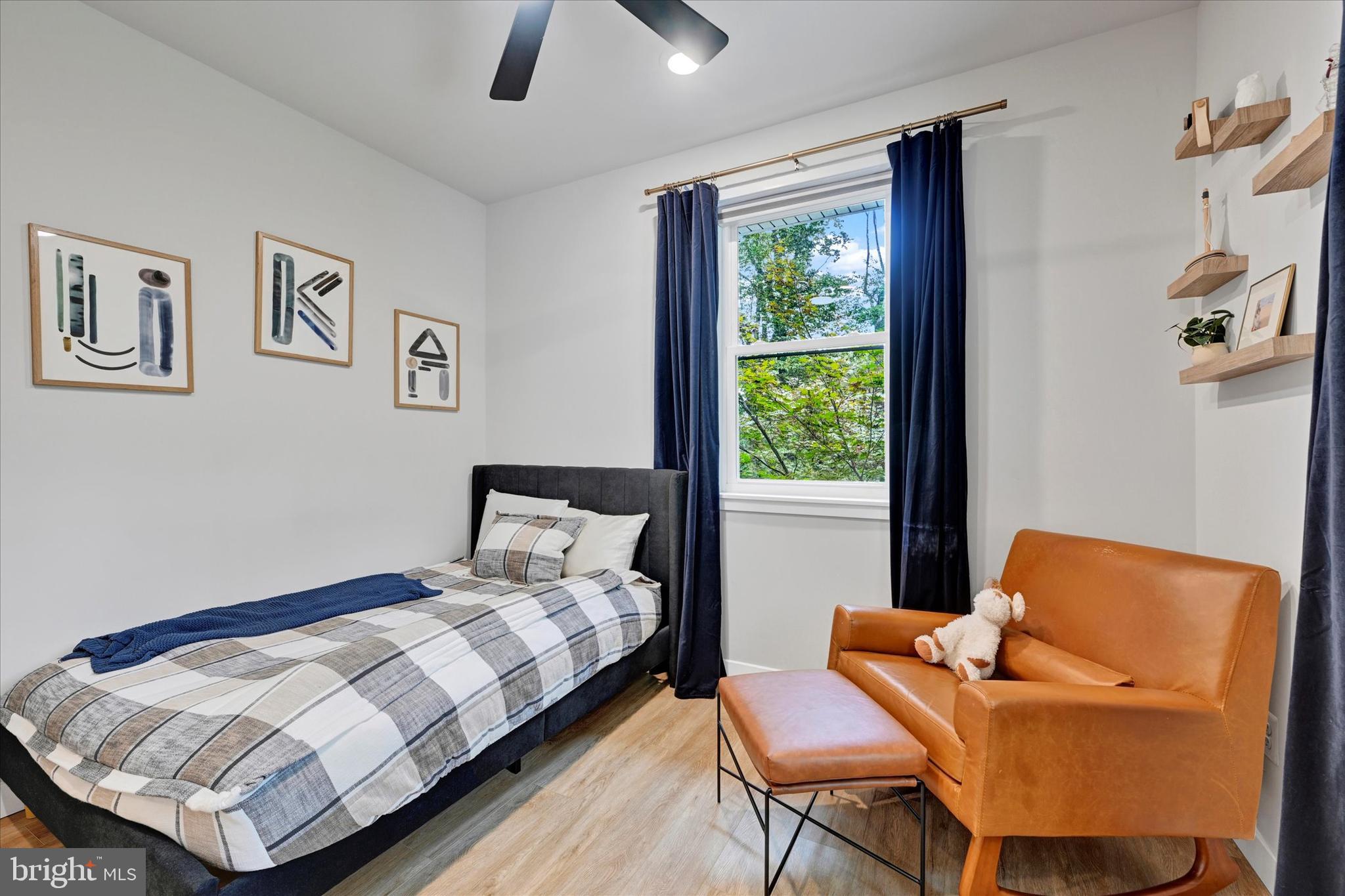 5437 Glen Arm Road Glen Arm, MD 21057 - Photo 35 of 45 a bedroom with a bed and wooden floor