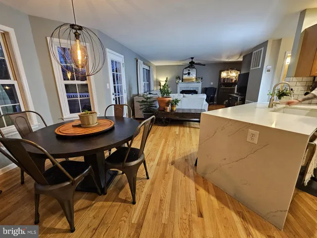 a view of a dining room with furniture and a chandelier