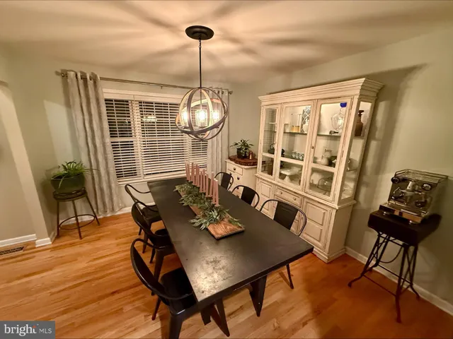 a view of a dining room with furniture wooden floor and chandelier