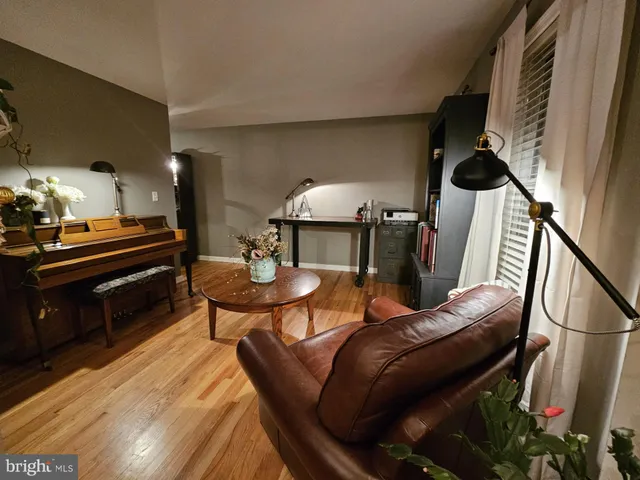 a living room with furniture and a piano
