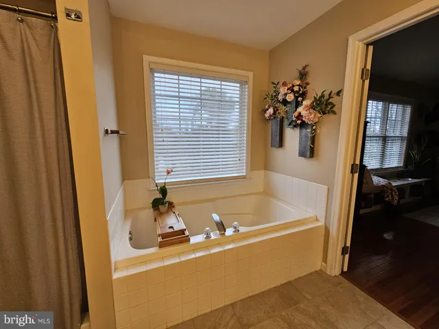 a bathroom with a tub and a sink