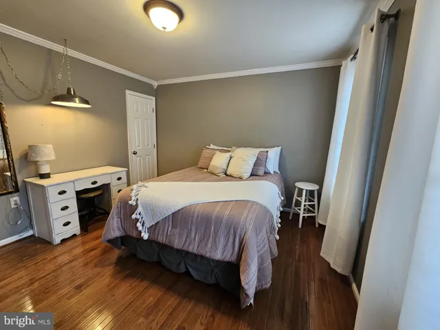 a bedroom with a bed and a view of kitchen