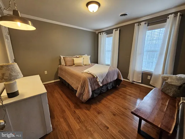 a bedroom with a bed and a mirror