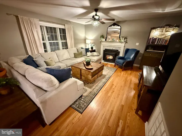 a living room with furniture fireplace and window