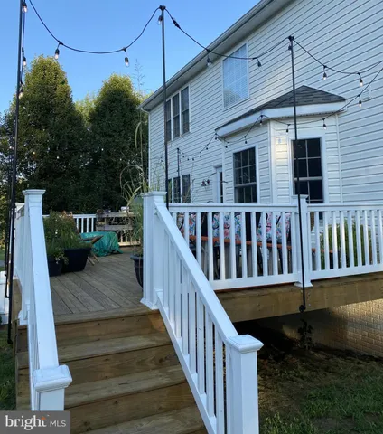 a view of a house with wooden deck