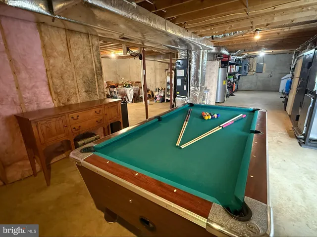 a room with pool table and windows