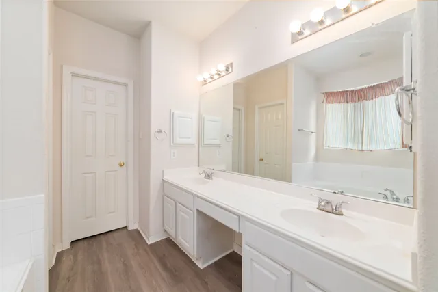 a bathroom with a sink a mirror and a shower