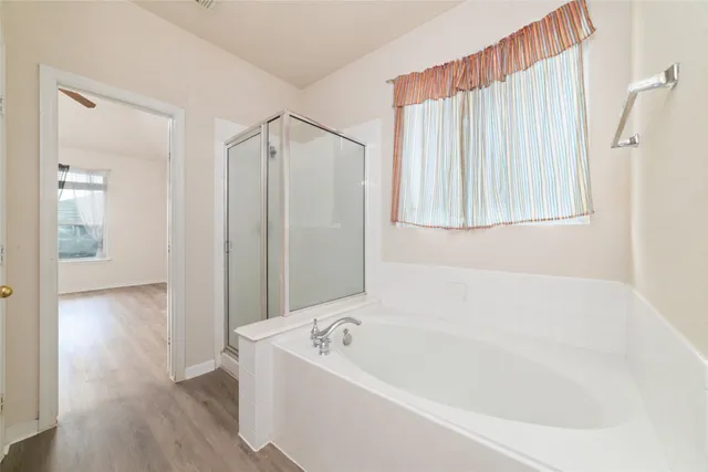 a bathroom with a bathtub and a shower