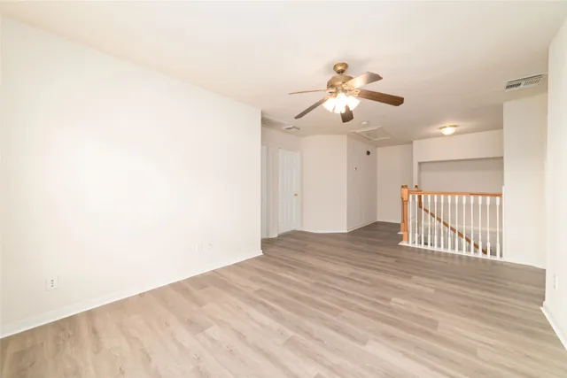 a view of a room with a ceiling fan