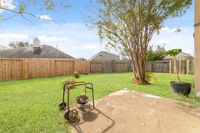 a view of a backyard with table and chairs and a slide