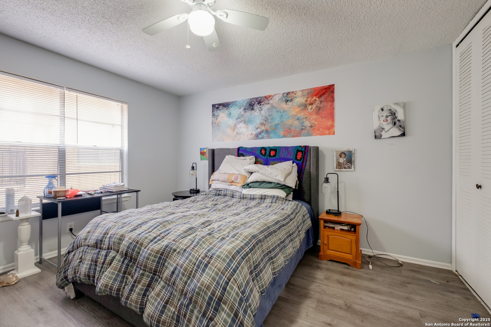 923 Vance Jackson Road, Unit 708 San Antonio, TX 78201 - Photo 11 of 18 a bedroom with a bed and a chandelier