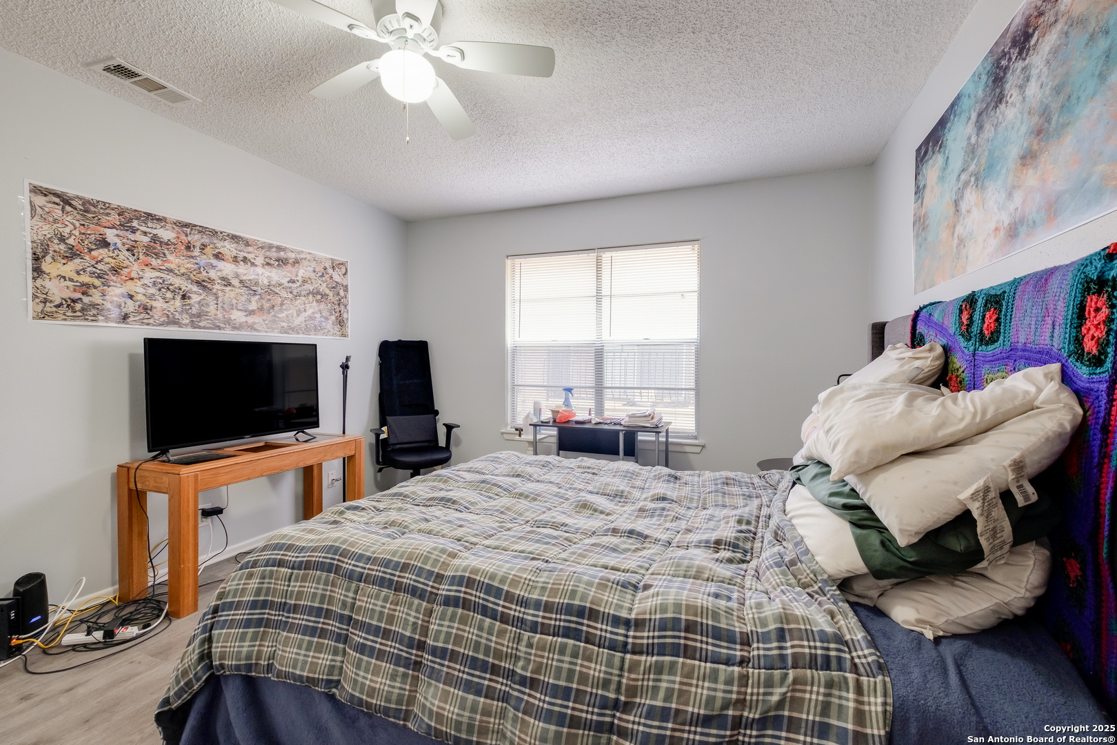 923 Vance Jackson Road, Unit 708 San Antonio, TX 78201 - Photo 9 of 18 a bedroom with a bed and a flat screen tv