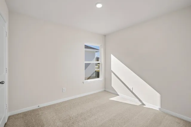 a view of an empty room with windows