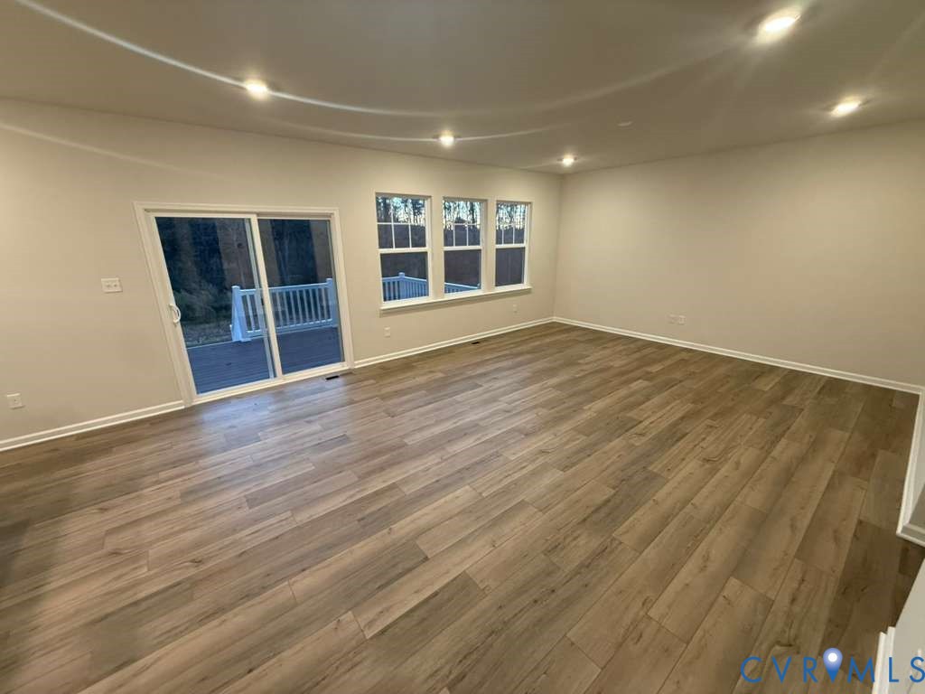 6454 Fennec Run Moseley, VA 23120 - Photo 13 of 24 an empty room with wooden floor and windows