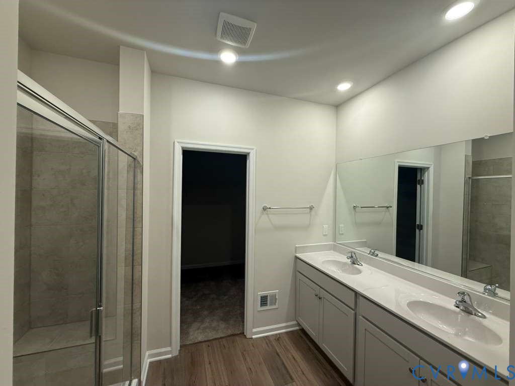 6454 Fennec Run Moseley, VA 23120 - Photo 24 of 24 a bathroom with a double vanity sink and mirror