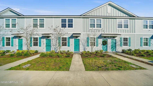 front view of a brick house with a yard