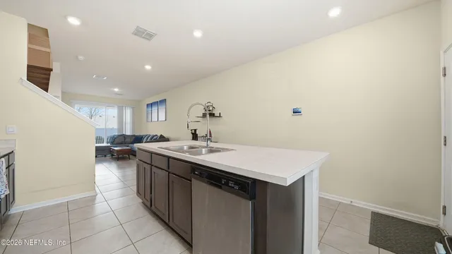 a kitchen with a sink a stove and cabinets