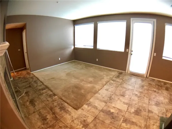 a view of an empty room and a window