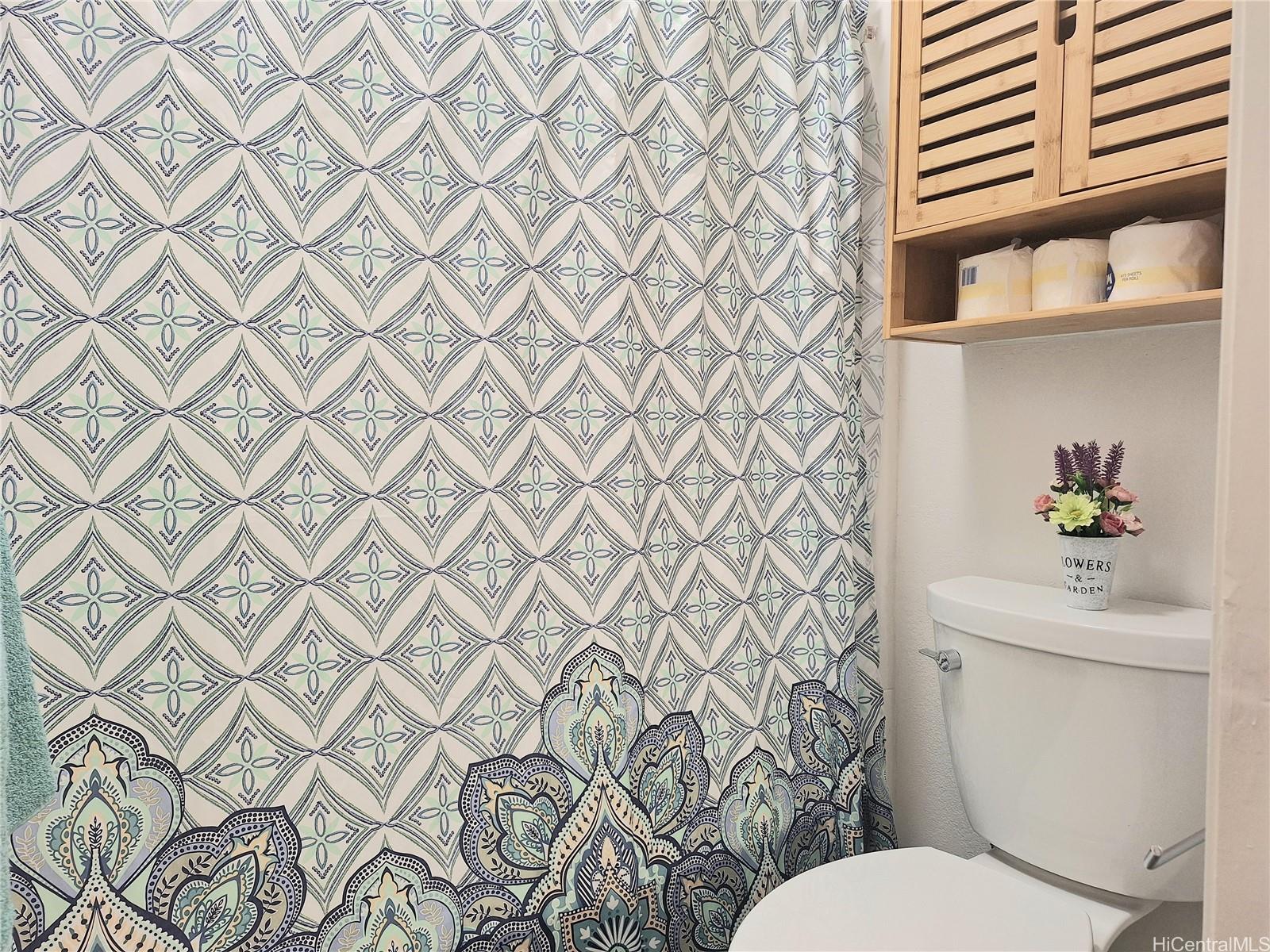 Undisclosed Address Ewa Beach, HI 96706 - Photo 11 of 11 a white toilet sitting next to a shower curtain