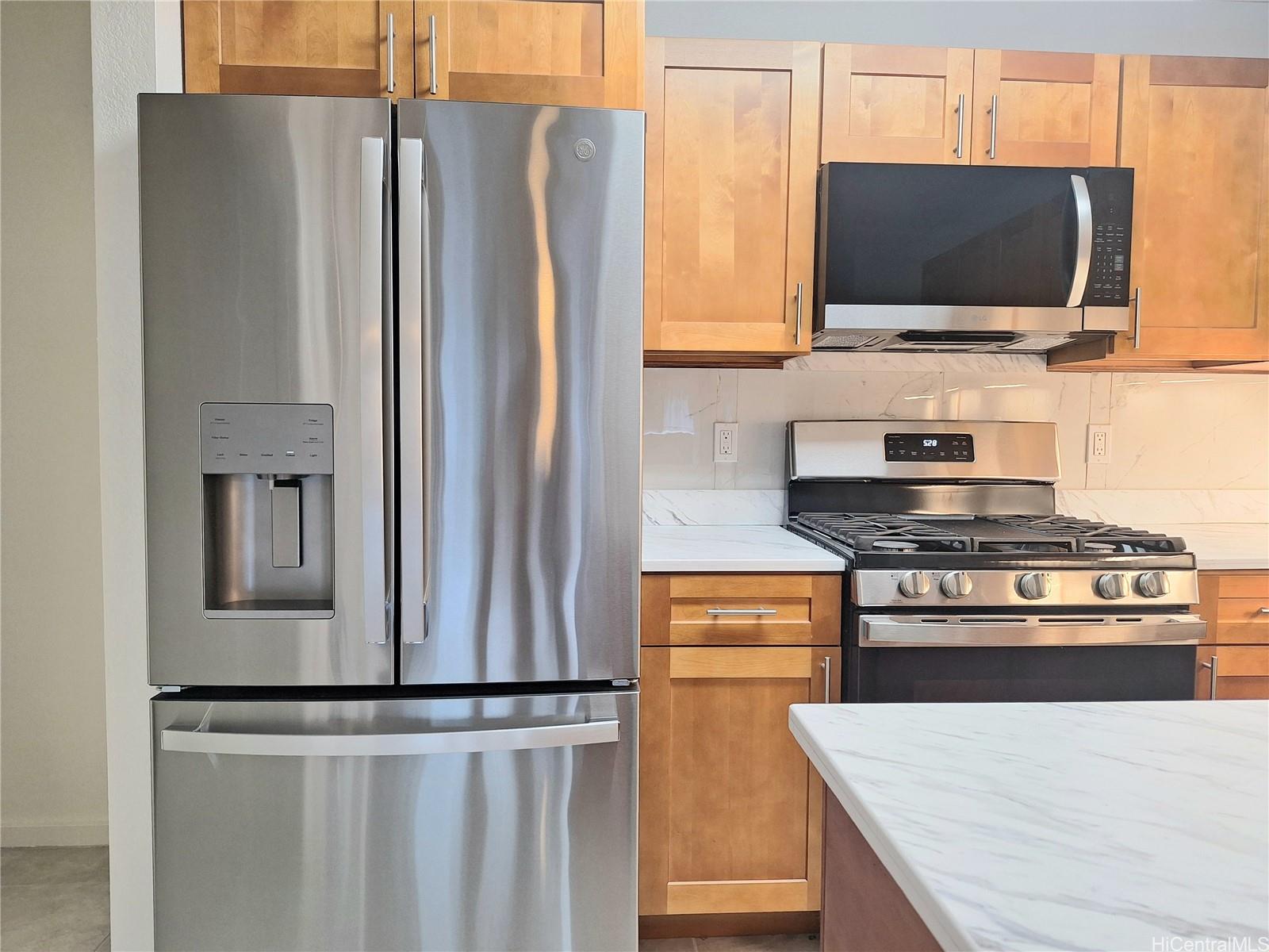 Undisclosed Address Ewa Beach, HI 96706 - Photo 3 of 11 a kitchen with stainless steel appliances a refrigerator and a stove top oven