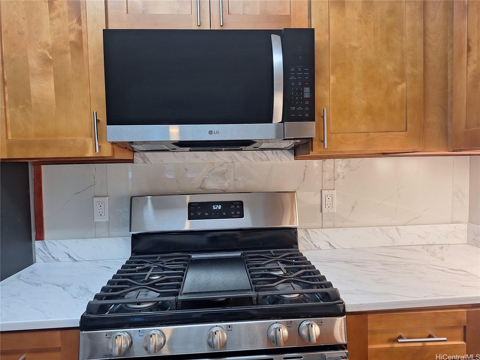 Undisclosed Address Ewa Beach, HI 96706 - Photo 5 of 11 a kitchen with stainless steel appliances granite countertop a stove and a microwave