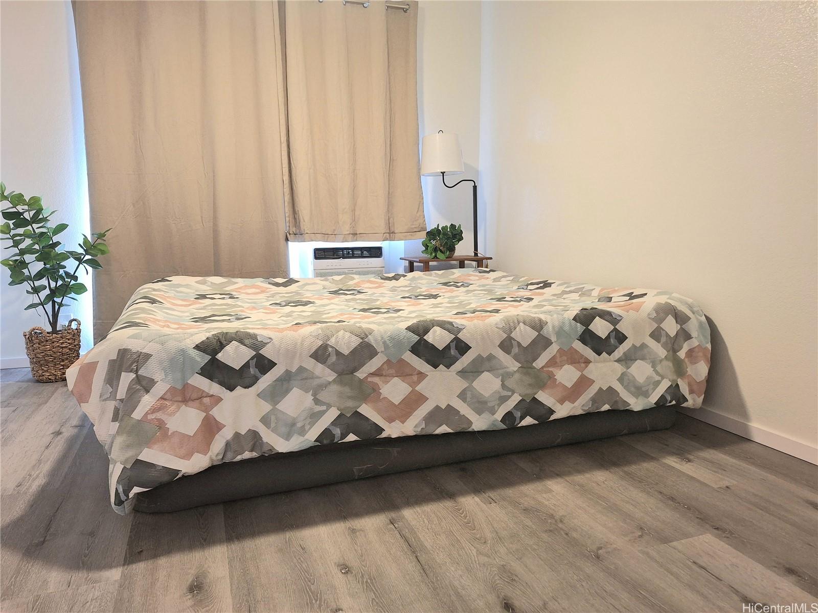 Undisclosed Address Ewa Beach, HI 96706 - Photo 8 of 11 a bedroom with a bed and a potted plant